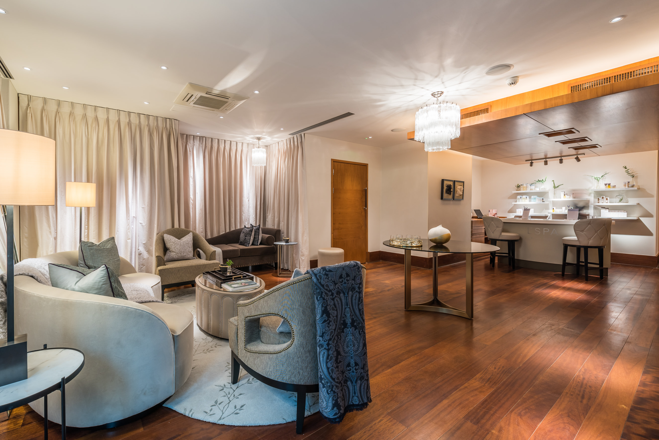 A reception room with soft furnishings and a curtained wall.