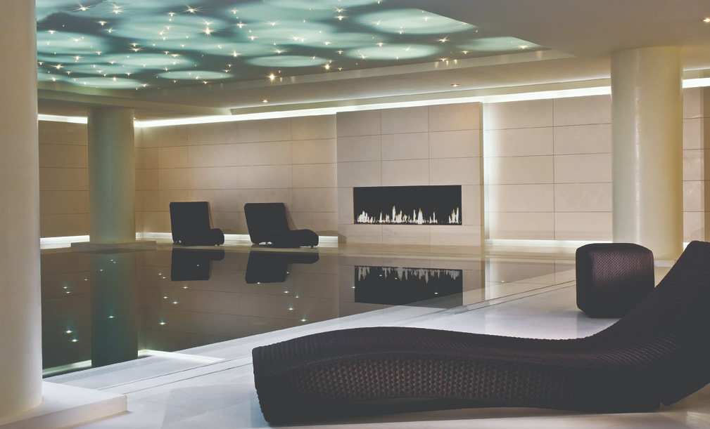 Calm indoor pool with reclined seats.